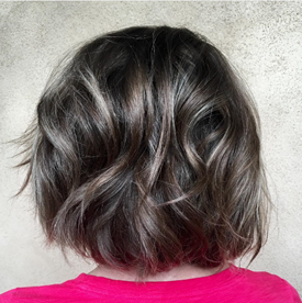 Model with dark hair and gray balayage.